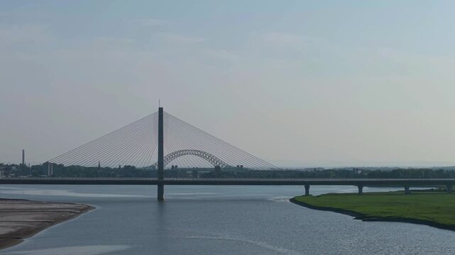 Liverpool, Merseyside, UK, June 19, 2025; Aerial 4K video footage of the Mersey Gateway toll bridge with stunning views over the River Mersey, Liverpool, UK.