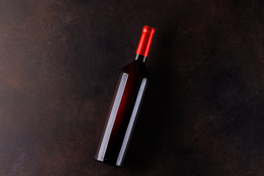 Red wine bottle on stone table top view