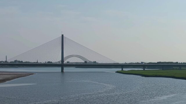 Liverpool, Merseyside, UK, June 19, 2025; Aerial 4K video footage of the Mersey Gateway toll bridge with stunning views over the River Mersey, Liverpool, UK.