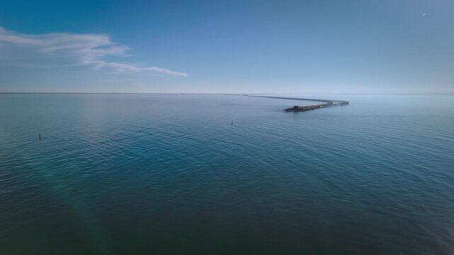 Aerial cinematic view of the Chesapeake Bay Bridge-Tunnel trestle and island in the Hampton Roads region of Virginia