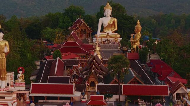 Aerial view of Wat Phra That Doi Kham, Buddha pagoda and golden chedi in Chiang Mai, Thailand.