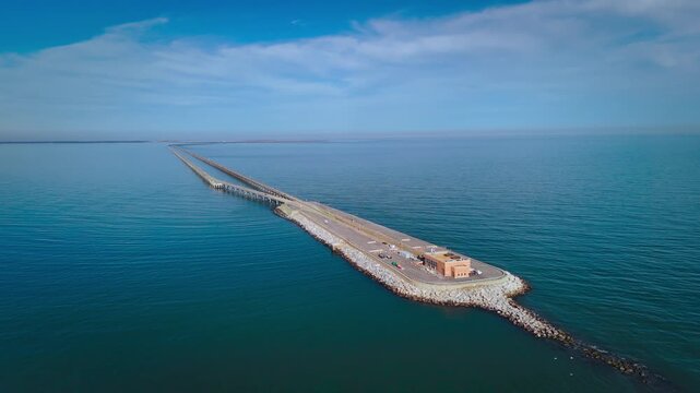 Aerial cinematic view of the Chesapeake Bay Bridge-Tunnel trestle and island in the Hampton Roads region of Virginia