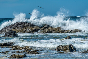 surf breaking over rocks in Playa Grande Costa Rica