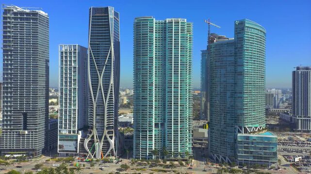 Modern skyscrapers with unique architectural designs against a clear blue sky