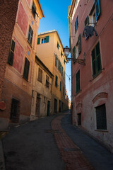 Obraz premium Picturesque narrow street with cobblestones and colorful houses, Nervi,