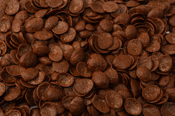 Corn-flakes background and texture. Chocolate cereal.