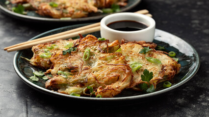 Korean cabbage pancake with vegetables and soy sauce. Asian food style © grinchh