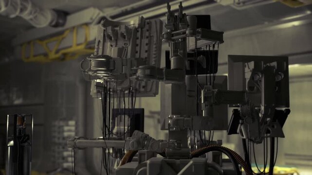 Mechanical control assembly with intricate components, gantry connectors, braided cables, servos and mounts, shallow depth of field, gritty industrial texture