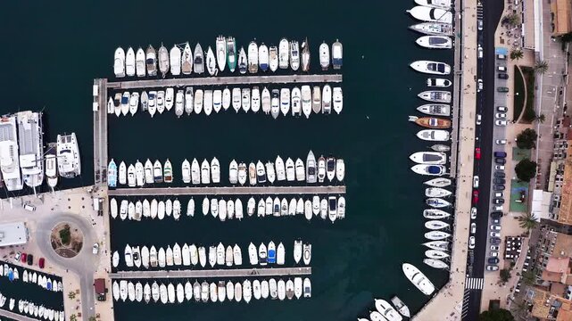 Breathtaking flying drone Aerial Perspective of Mediterranean Sea Harbor, Overflowing with Magnificent Luxury Yachts at the Bustling Marina Docks, Port de S&oacute;ller, Balearic Islands, Mallorca, Spain
