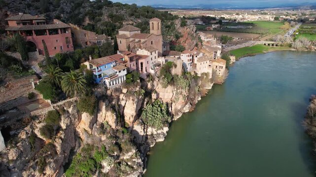Tilt down aerial footage of Miravet town and Ebro river. Tarragona, Spain.