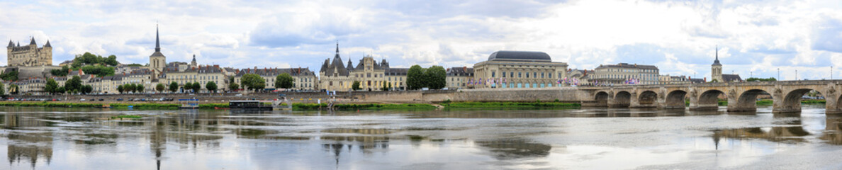 Fototapeta premium Saumur panorama, France, located at the Loire river under a beautiful cloudscape during daytime.