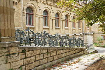 Pushkin bath in Pyatigorsk. Historic brick building with arched windows and ornate wrought-iron railing. © o1559kip