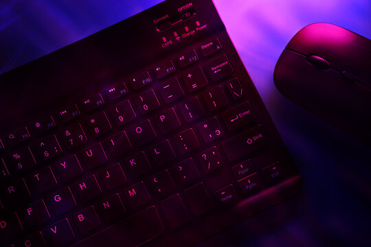 Futuristic keyboard with glowing keys in purple light