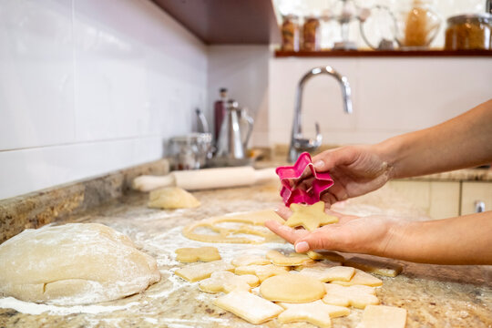 Homemade cookies in kitchen with cutter on counter
