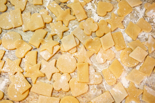 Homemade cookie dough in various shapes on countertop