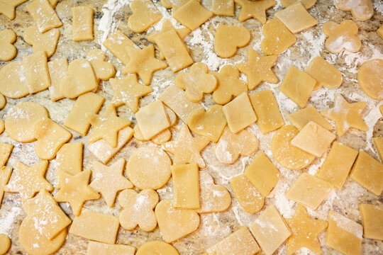 Homemade cookie dough in various shapes on countertop