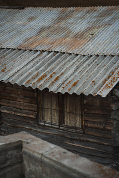 Rustic wooden cabin with corrugated roof
