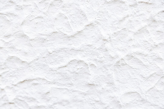 White textured wall background with irregular patterns