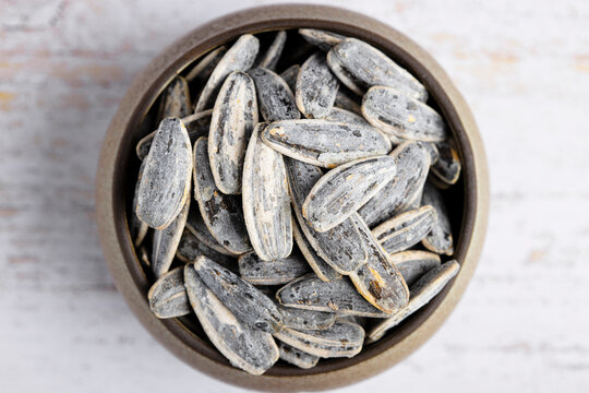 Salted sunflower seeds in ceramic bowl