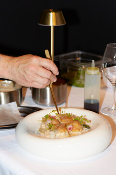 Chef adding final touch to gourmet dish in restaurant