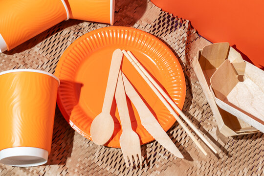 Disposable tableware with orange paper plate and cups