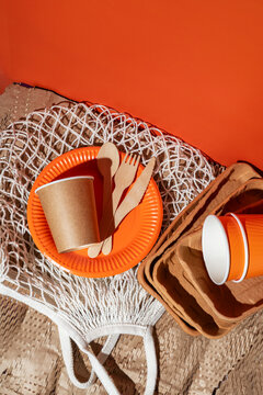 Eco-friendly disposable tableware and utensils in orange