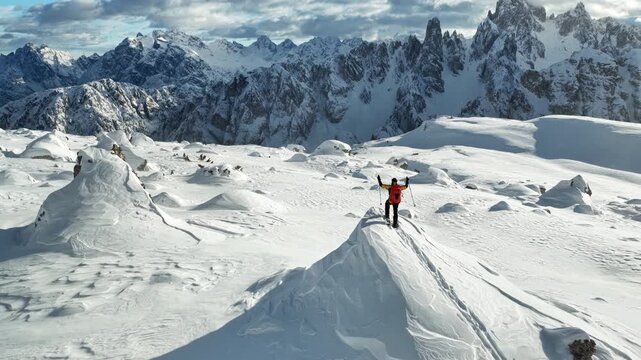Beautiful Winter Dolomite Mountain Scenery with Man on Cross-Country Skis , Aerial View