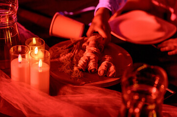 Table setting with candles and decorative food items in dim lighting © bo.kvk