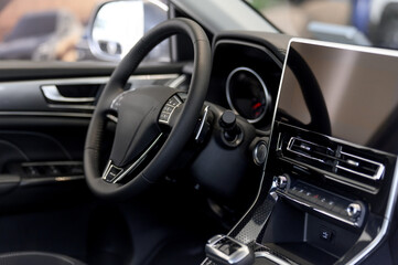 Modern car interior with steering wheel and touchscreen display visible