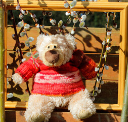 The teddy bear has a new hand-knitted wool pullover.