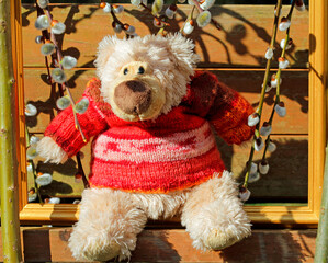 The teddy bear has a new hand-knitted wool pullover.