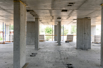 Empty concrete construction site with columns and unfinished walls