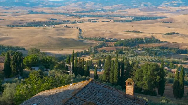Scenic tuscany landscape with rolling hills and cypress trees. Panoramic view panning across the iconic tuscan countryside, revealing rolling hills, golden fields, traditional farmhouses