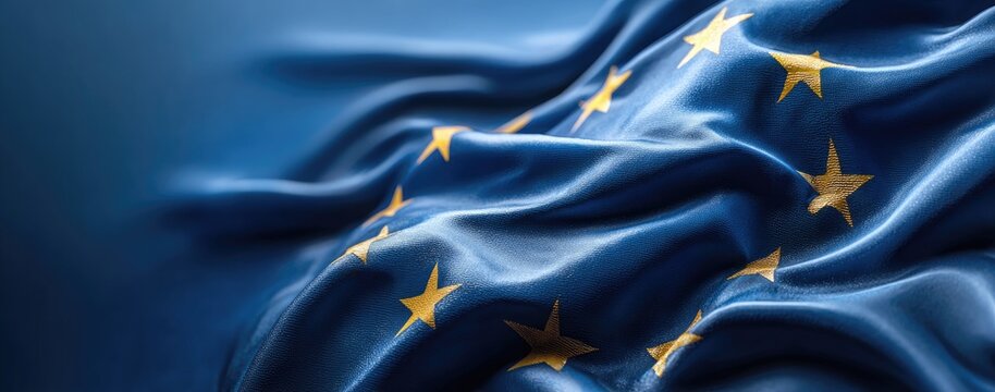 Waving European Union Flag with Golden Stars on Blue Fabric.