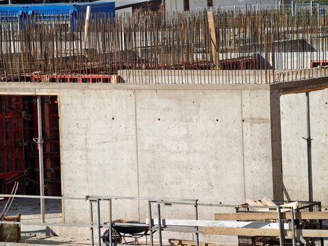 Early phase of building process displaying uncompleted concrete skeleton and supportive reinforcements