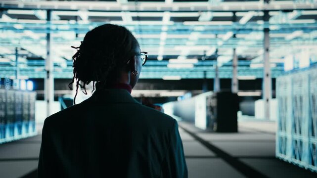 Debugging system errors, AR technology and software developer in data center using tablet. Running equipment diagnostics, wireframe mesh supercomputer and professional walking in server farm, camera A