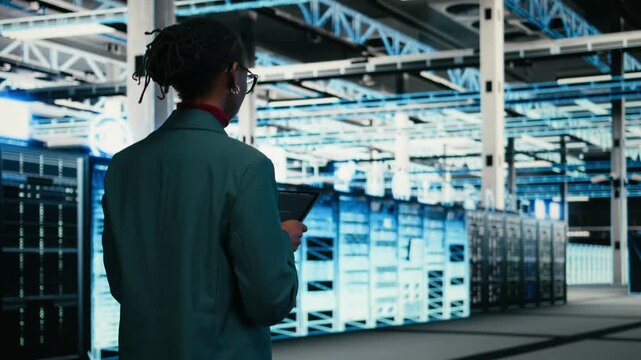 Writing code, tablet and female programmer walking in data center, compiling software patches. Running programming script, device application and African american woman in server hub, camera A