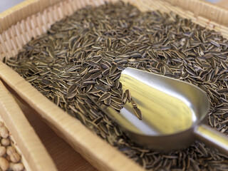 Metal Spoon Resting in Woven Basket of Sunflower Seeds