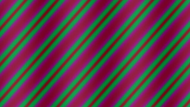 Vibrant diagonal striped pattern with purple, green, pink, and red colors, abstract background design with dynamic gradient effect and colorful stripes