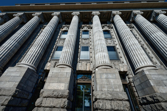 Low angle view of the monumental columns and ornate facade of the former Reichsbahndirektion building in Cologne, Germany. Classicist architecture