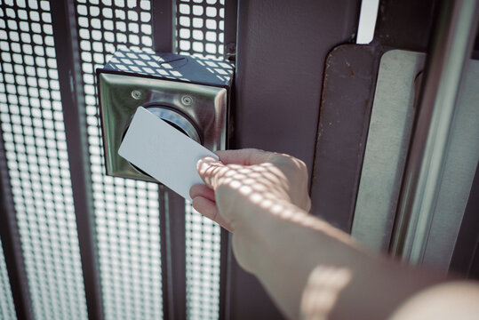 Bright coastal light surrounds the pool gate reader as the hotel card moves toward the embedded RFID sensor for verification. Textured steel, patterned highlights, soft gradients, California
