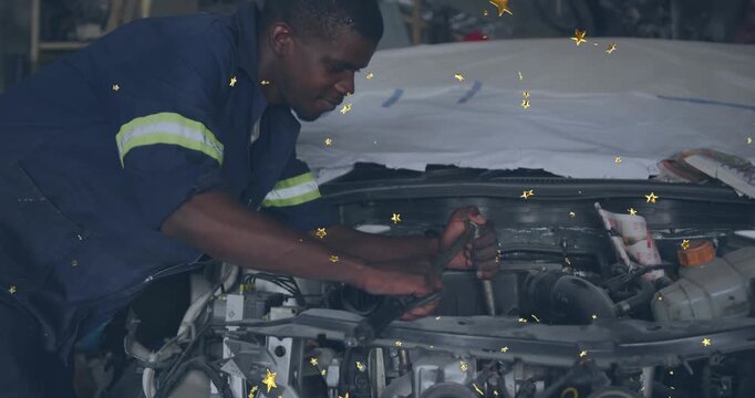 Mechanic leaning over automotive bay, gripping breaker bar, loosening pulley while stars overlaying