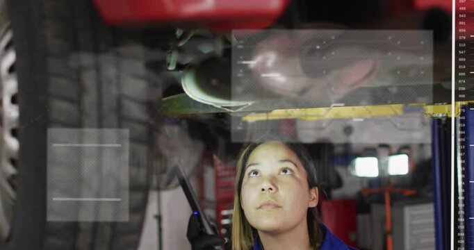 Auto tech bringing LED light, inspecting underbody and scanning for faults as HUDs shifting above