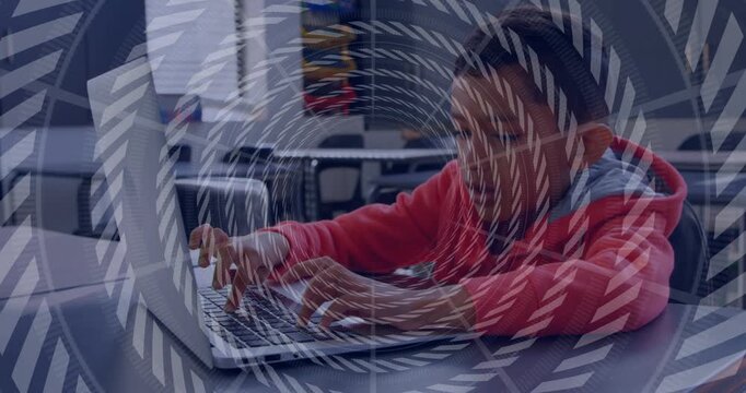 Boy typing on laptop in classroom, spiral overlay rotating and syncing with keystrokes for learning
