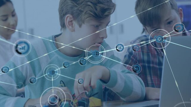 Two boys wiring and using laptop for STEM, node appearing over left boy and expanding overlay