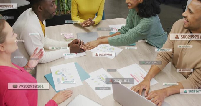 Team reviewing charts, teammate sliding sheet, data overlaying papers, stacking hands for business