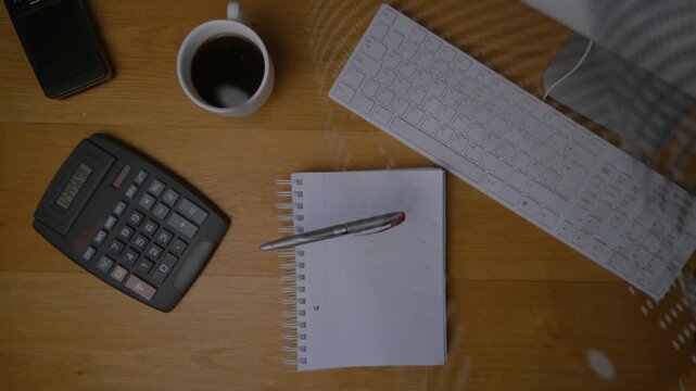 Metal pen entering as mesh starting sweep, casting dotted shadows and rolling to notebook center