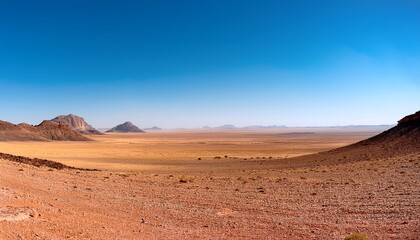 Fototapeta premium wide empty desert landscape with distant rocky hills under clear blue sky vast arid plain with open horizon and minimal natural terrain ideal for nature backgrounds travel concepts