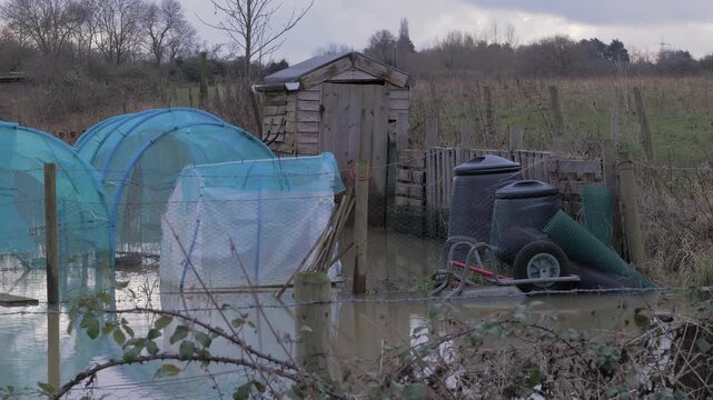winter flooding, shed, planting tunnels, mesh netting, compost bins, flooded with water, winter afternoon light