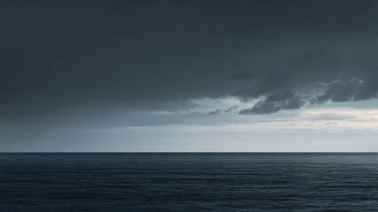 A simple horizontal line dividing a dark gray sky and a black sea
